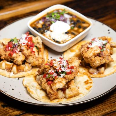 Breaded chicken on flour tortillas.