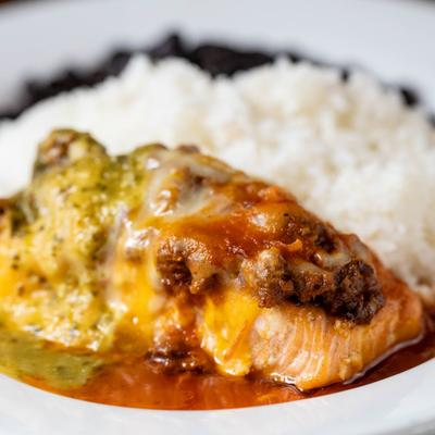 Salmon, topped with chorizo, melted cheddar, and green and red sauce.