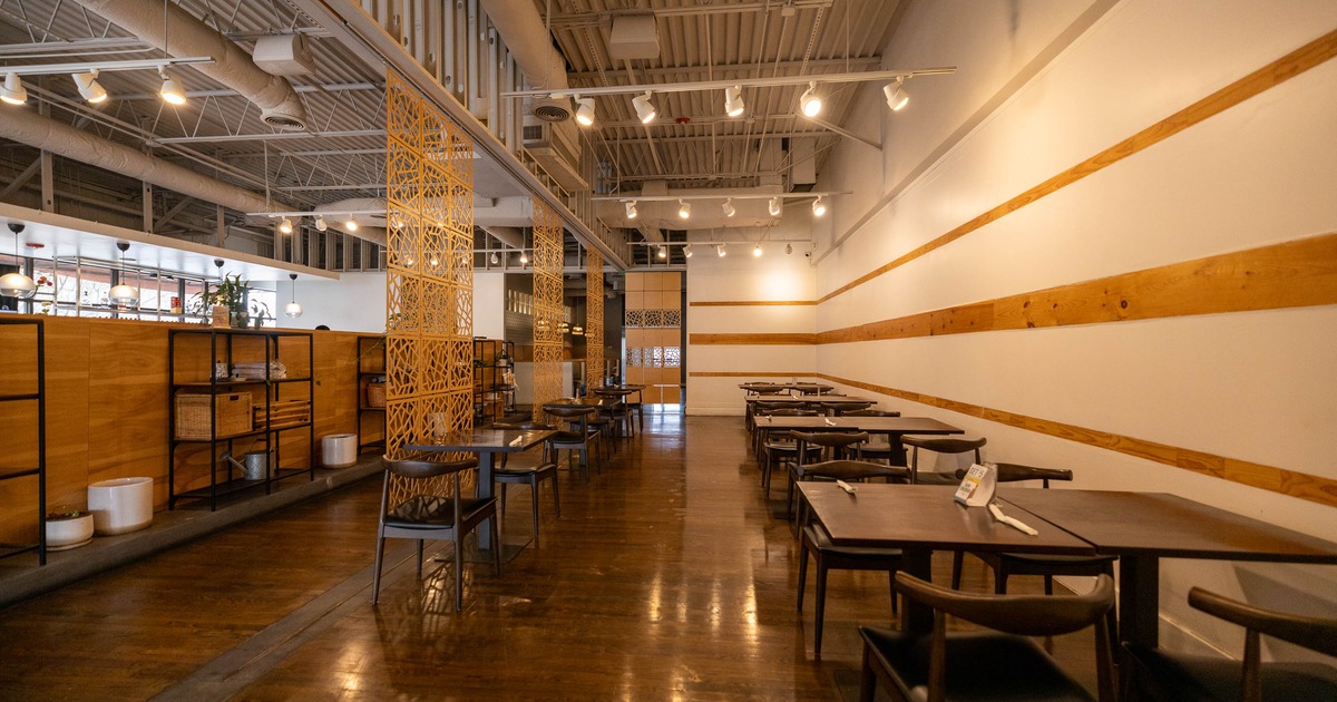Interior of a modern, minimalist restaurant with wooden floors