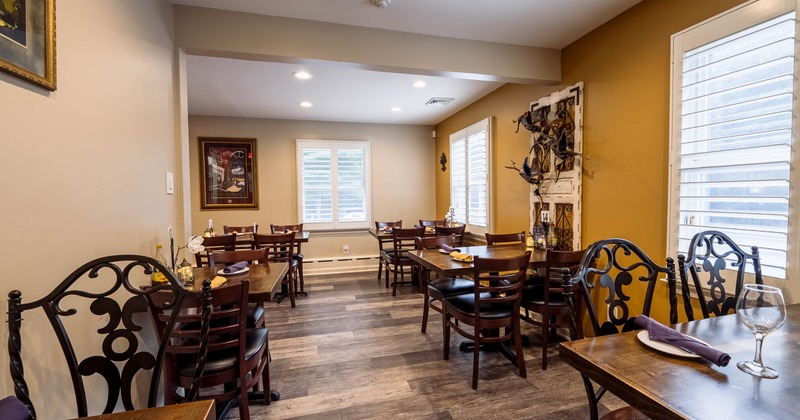 Interior, dining area, wooden top tables for four with iron and wooden chairs