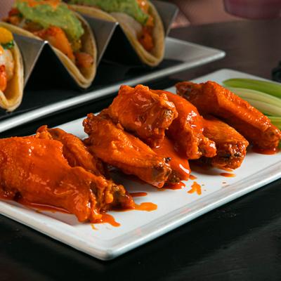 Chicken wings served with celery.