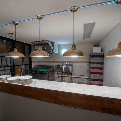 The interior of a commercial kitchen and counter are.