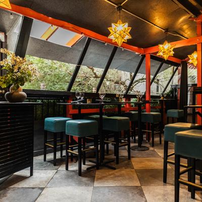 Interior, seating area, high top tables and chairs.