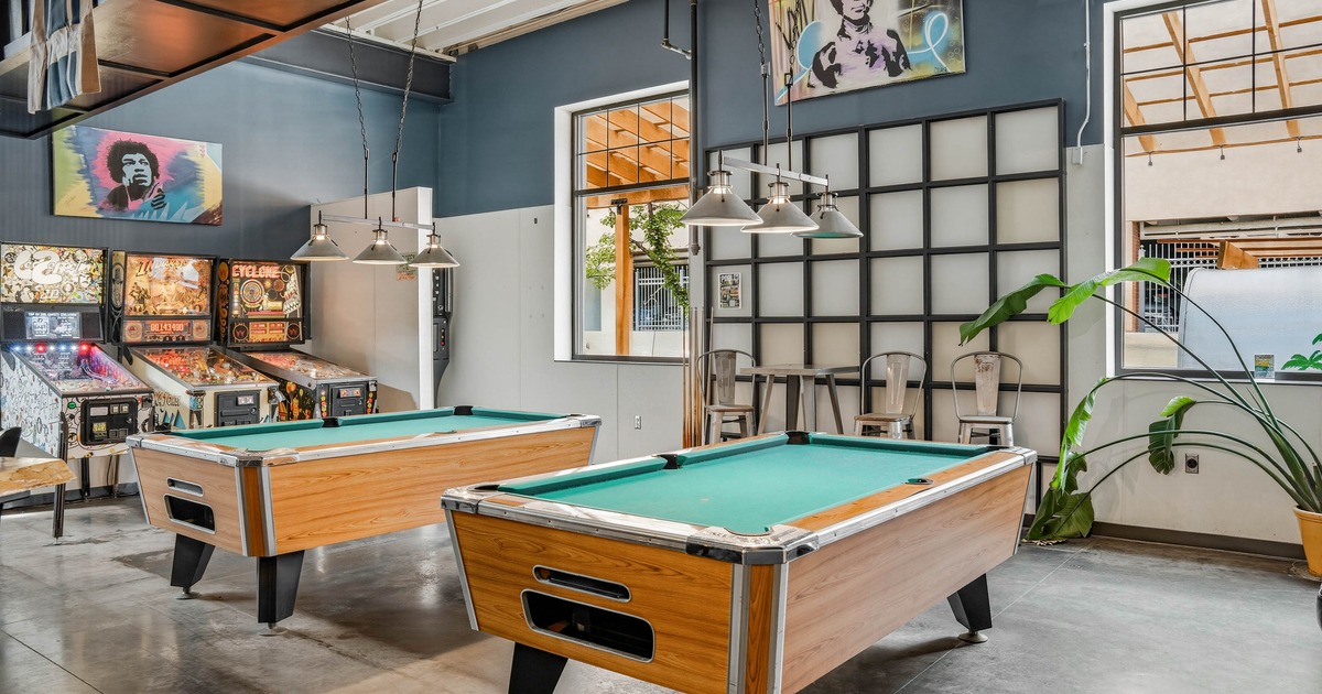 Pool tables and arcade games in the background