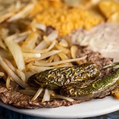 Skirt steak, with grilled onions, jalapenos, rice, beans and tortillas