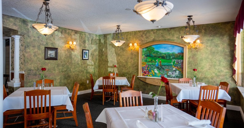 Interior with wooden furniture, green walls, a mural and elegant lighting