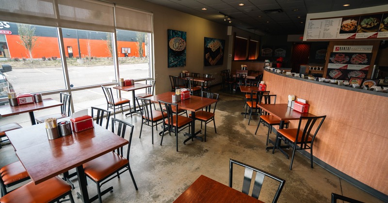 Interior, tables and chairs near bar