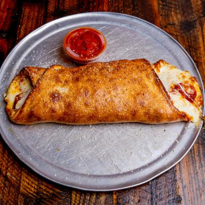 Pepperoni and cheese Stromboli, with marinara sauce.