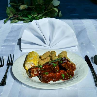 BBQ ribs with sides, served on the table.