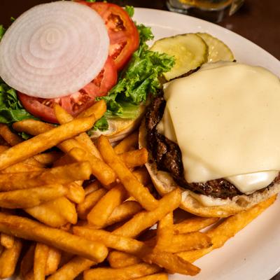 Cheeseburger served with fries, lettuce, tomato, sliced red onion and pickles.