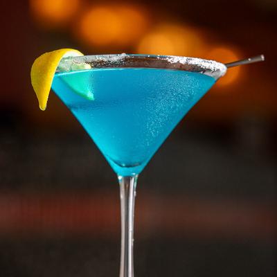 Blue cocktail in a martini glass.