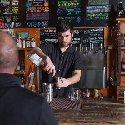 A staff member preparing a drink for a guest.