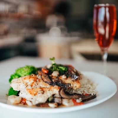 Grilled chicken breast, with rice, mushrooms, and mixed vegetables.