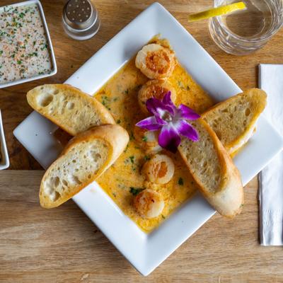 Seared Scallops served with a toasted bread.