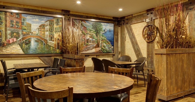 Interior, dining area, tables for four, ready for guests, large format paintings as a decoration