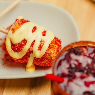 Street corn covered in cheese and chili.