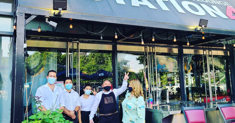 Exterior, employees posing for the photo in front of the restaurant