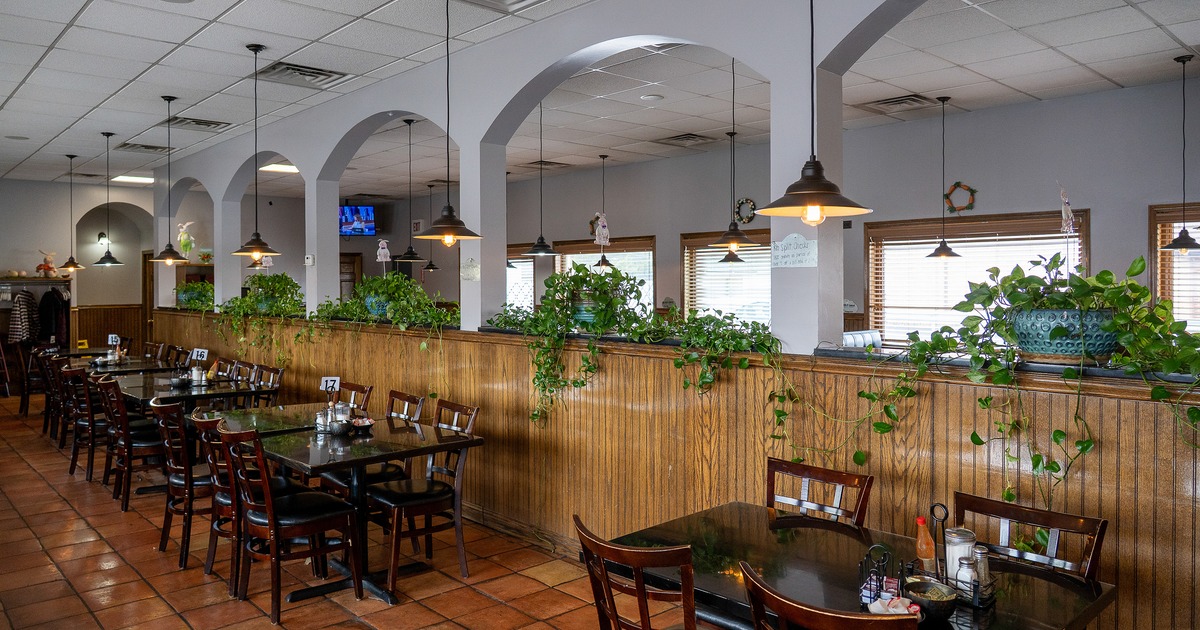 Cozy interior dining area with wooden tables and chairs ready for guests