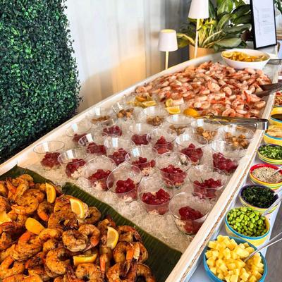 Grazing table with a variety of seafood and brunch items.