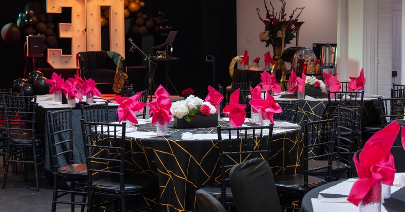 Interior, event area, round tables for eight, band stage in the back
