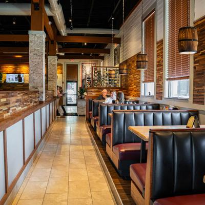 Restaurant interior featuring booth seating and tiled floors.