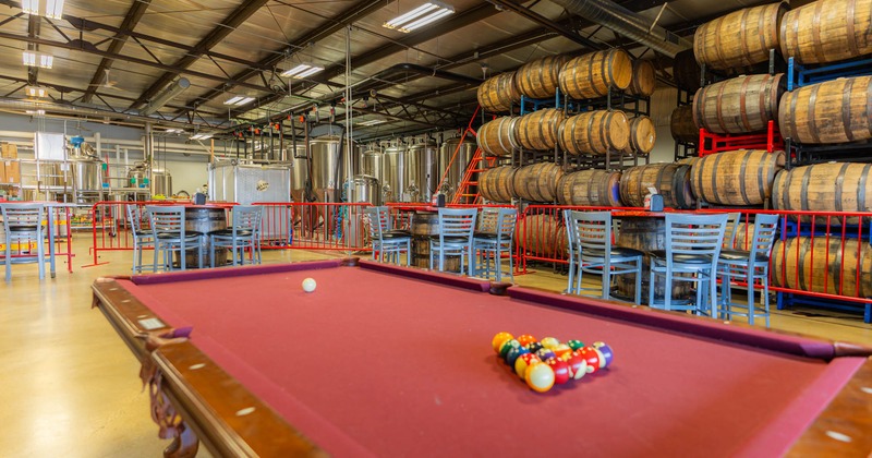 Interior, pool table, tables and chairs around