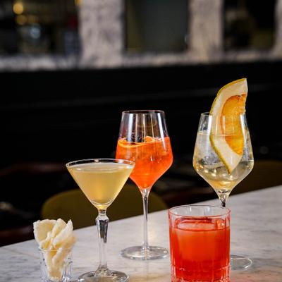 Elegant cocktails with citrus garnish on a marble counter.
