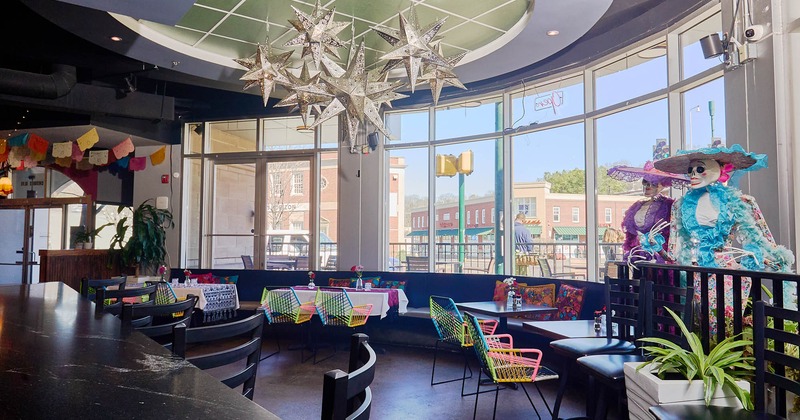 Interior, seating area with decorations and big windows in the back