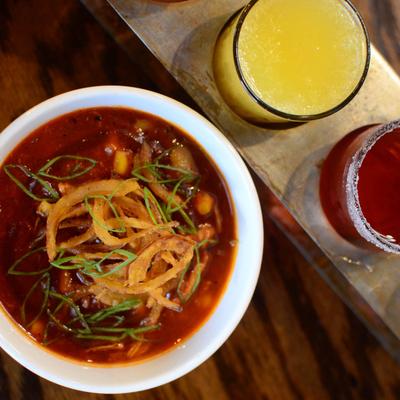 Brunswick Stew bowl sits next to a flight of mimosa.