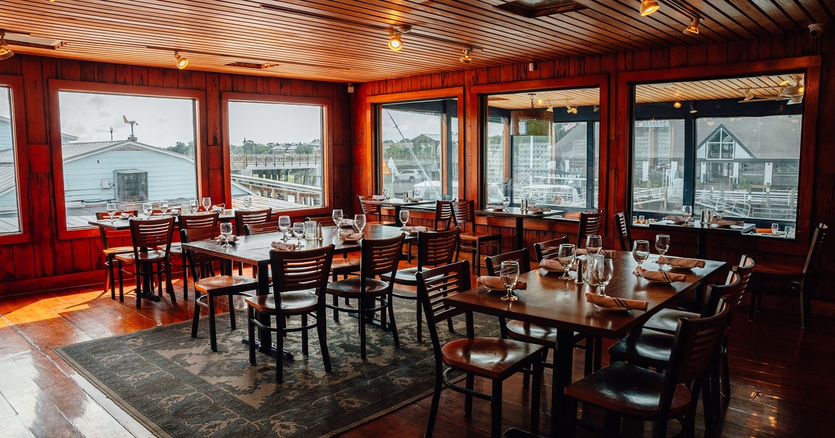 Inside, dining tables near windows, tableware