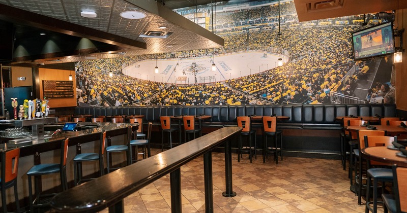 Interior, seating area with long banquette seating, wallpaper