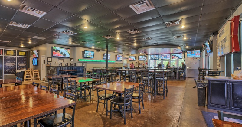 Interior, seating, lots of TVs on walls