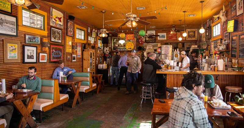 Interior, wooden, tables and chairs, framed pictures on the walls