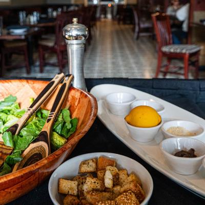 The components for a Caesar salad served in dishes on a table