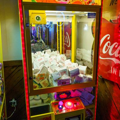 Claw machine filled with takeout boxes.