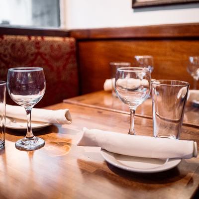 Interior, tables with tableware and glasses.