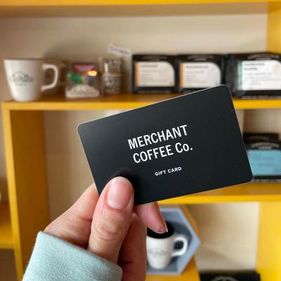 A hand holding the restaurant's card.