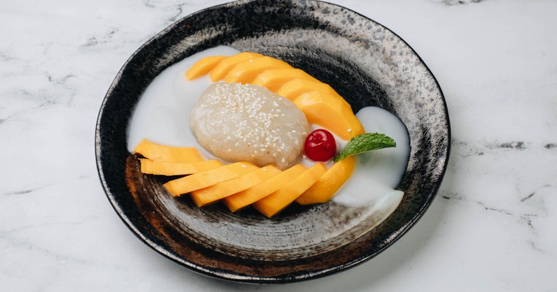 Sticky rice served with sliced mango and coconut milk sauce