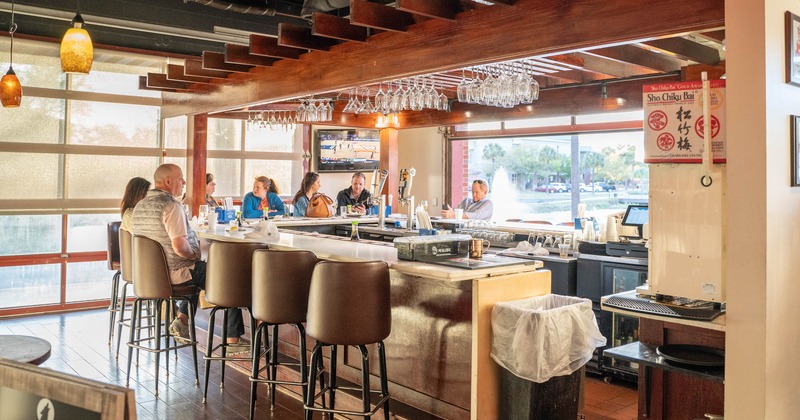 Interior, guests sitting at the bar