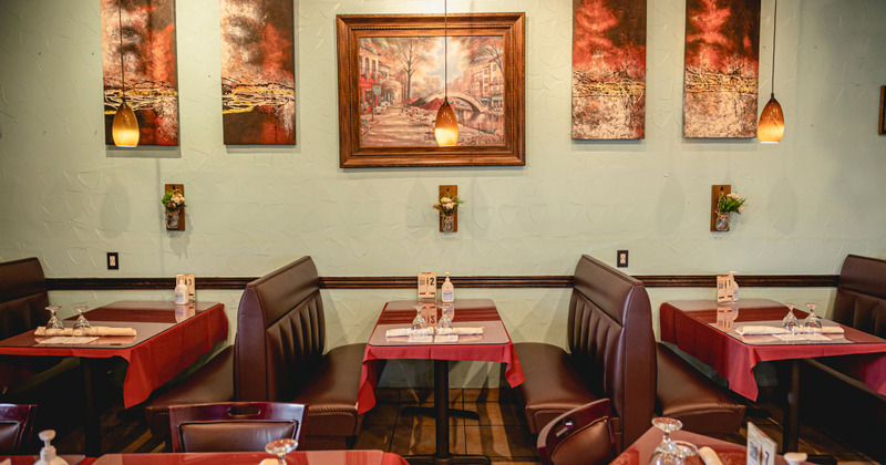 Interior, booths by a wall decorated with pictures