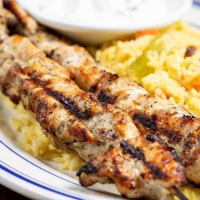 Grilled chicken skewers and rice.