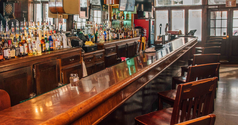 Interior, bar area with liquor bottles in the back