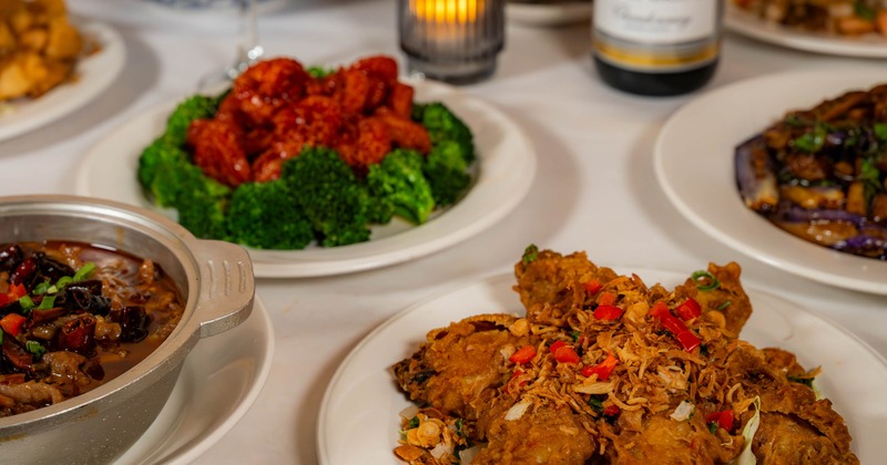 Table with multiple dishes including wings and fried chicken