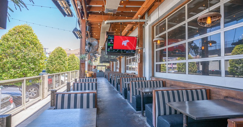 Exterior, seating area with inline booths and TV screens