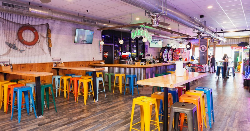 Interior, colorful stools, wooden tables, neon sign