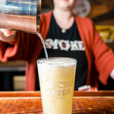 Bartender pouring a cocktail.