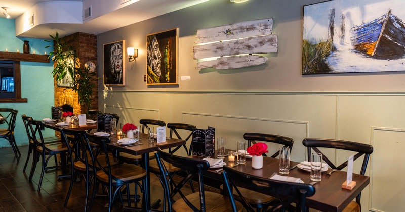 Interior, chairs and tables, paintings on the wall