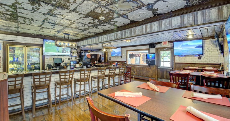 Interior, tables and chairs near bar