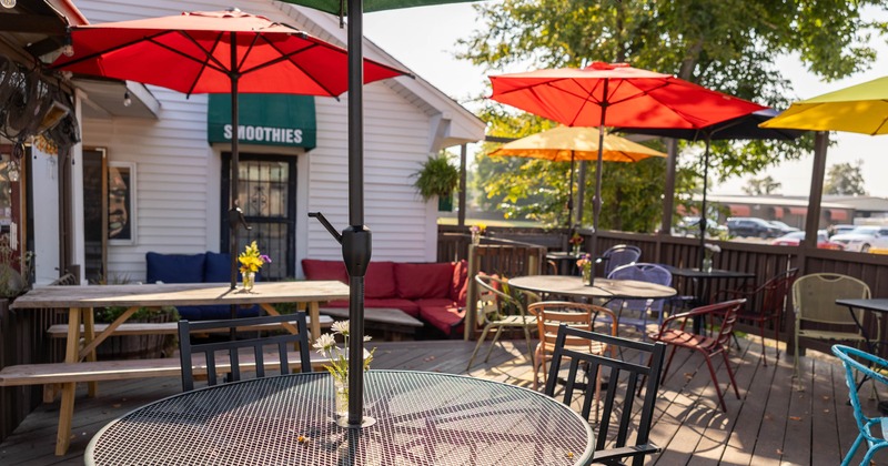 Outdoor cafe seating area with colorful umbrellas and tables