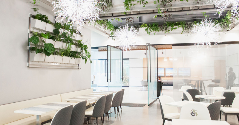 Interior, dining banquette seating by a wall, tables and chairs